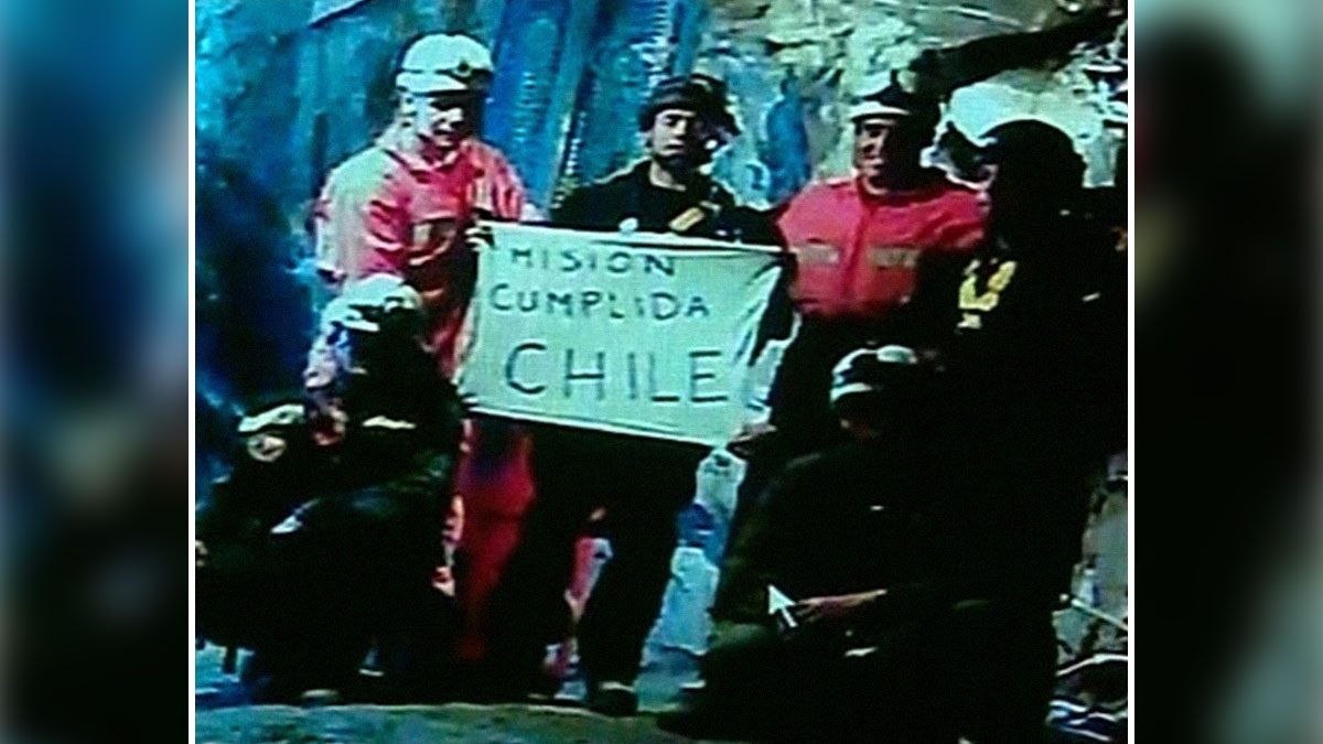 Rescue team in a mine holding a mission completed sign, representing unbelievable historical events people survived in Chile.
