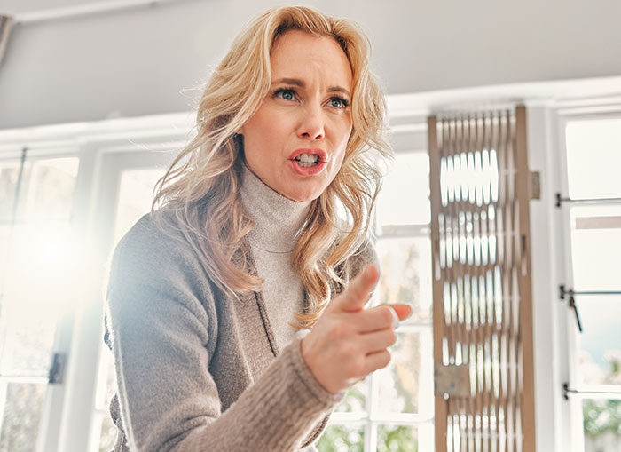 Angry woman pointing finger indoors, portraying confusion and frustration after a relationship test involving boyfriend’s sister. Angry woman pointing finger indoors, portraying confusion and frustration after a relationship test involving boyfriend’s sister.