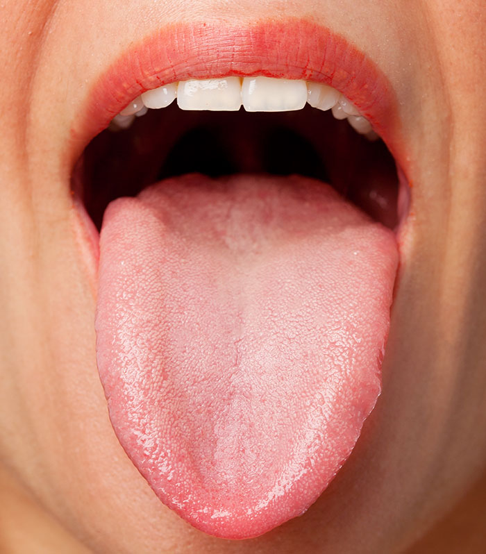 Close-up of a person’s tongue sticking out, illustrating surprising body quirks that reveal unique human features.