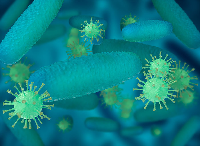 Microscopic view of body quirks showing bacteria and viruses interacting inside a human system in blue-green colors.