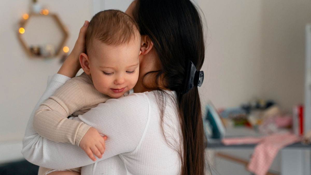 Woman holding toddler close, showing concern and care, highlighting babysitting and child safety themes.