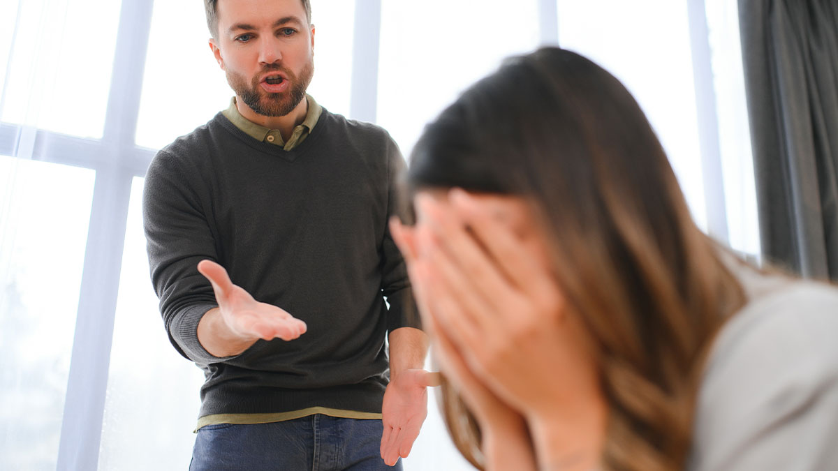 Man demands divorce from wife, arguing about weight and laziness, while she covers her face in distress during argument.