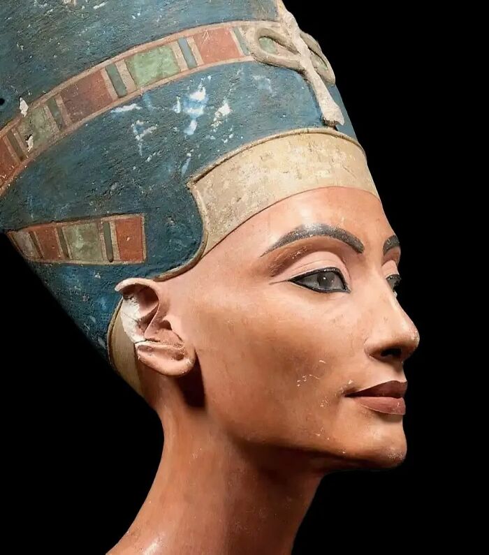 Bust of Queen Nefertiti with a colorful headdress showcasing historical beauty standards and artistic style.