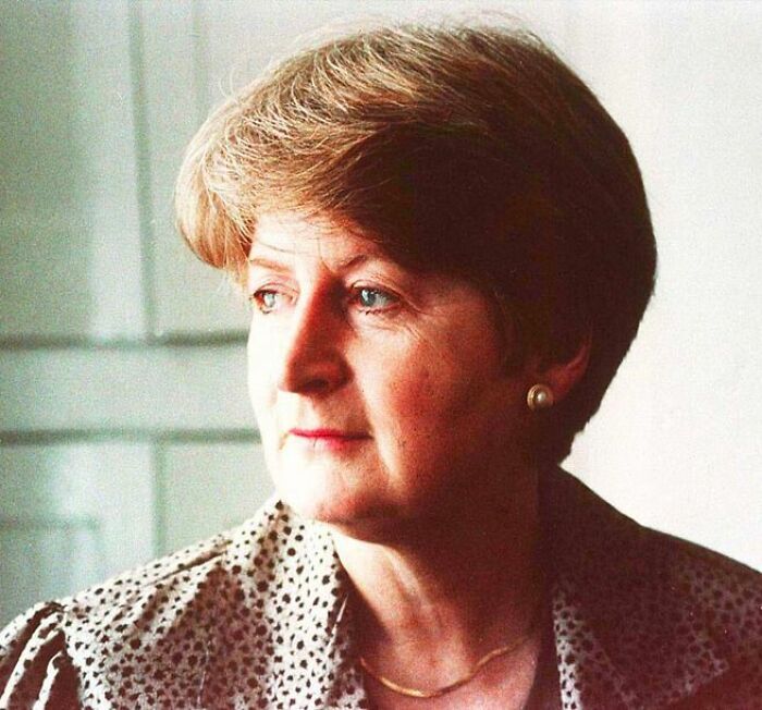 Portrait of a woman with short hair and pearl earrings, related to chilling disappearances from the ’90s mystery.