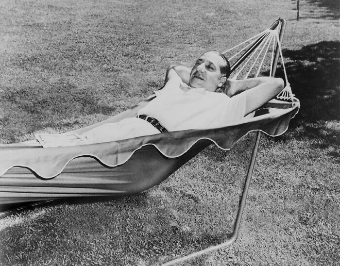 Notorious mob boss relaxing on a hammock outdoors, representing infamous figures in organized crime history.