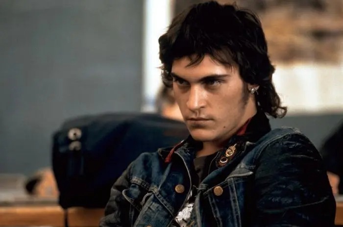 Young male actor with intense expression wearing a denim jacket, embodying the ultimate heartthrob style of his time.