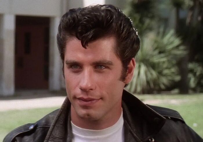 Young male actor with styled dark hair wearing a leather jacket, embodying the classic ultimate heartthrob look of his time.