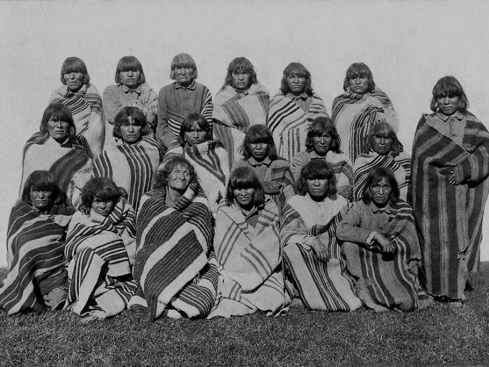 Group of Native American women wrapped in striped blankets, a rare glimpse into the harsh reality of life on Alcatraz.