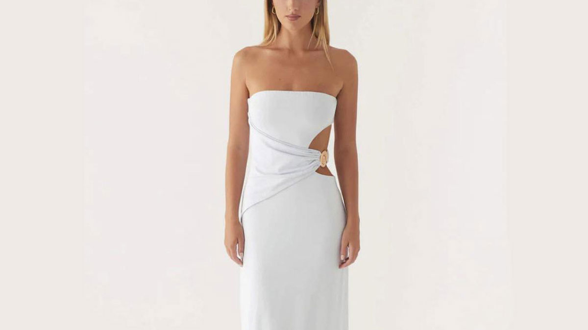 Woman in a white strapless dress with a side cutout and wrap detail, illustrating sibling shenanigans concept.
