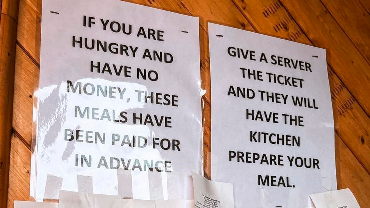 Signs in a creative bar or restaurant offering prepaid meals for hungry guests without money around the world.