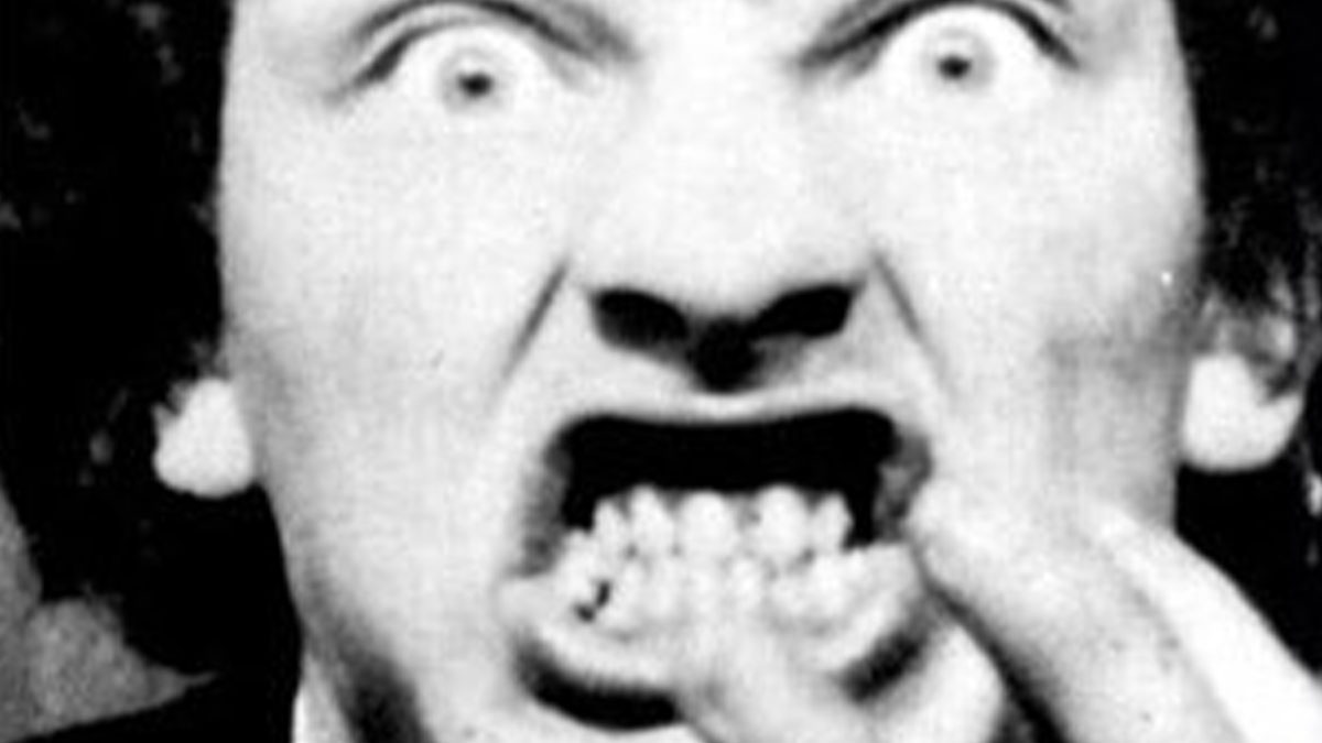 Close-up of a creepy face with wide eyes and distorted teeth, evoking unsettling and random creepy facts imagery.