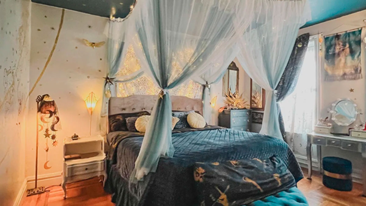 Cozy bedroom corner with a canopy bed and celestial-themed decor showcasing proud home decorating details