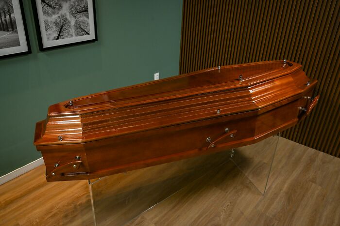 Wooden coffin displayed indoors, highlighting unique and unexpected items on wedding registries.