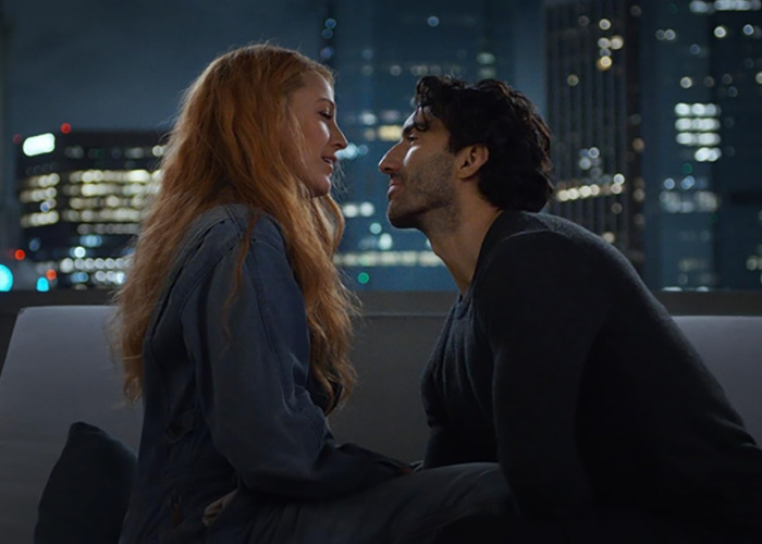 Romantic scene between Blake Lively and co-star at night in new rom-com, capturing intimate city rooftop moment. Romantic scene between Blake Lively and co-star at night in new rom-com, capturing intimate city rooftop moment.
