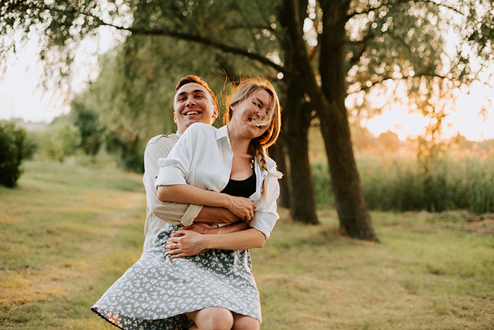 Couple embracing and smiling outdoors in a park setting, symbolizing post-breakup woman retains dog updates. Couple embracing and smiling outdoors in a park setting, symbolizing post-breakup woman retains dog updates.