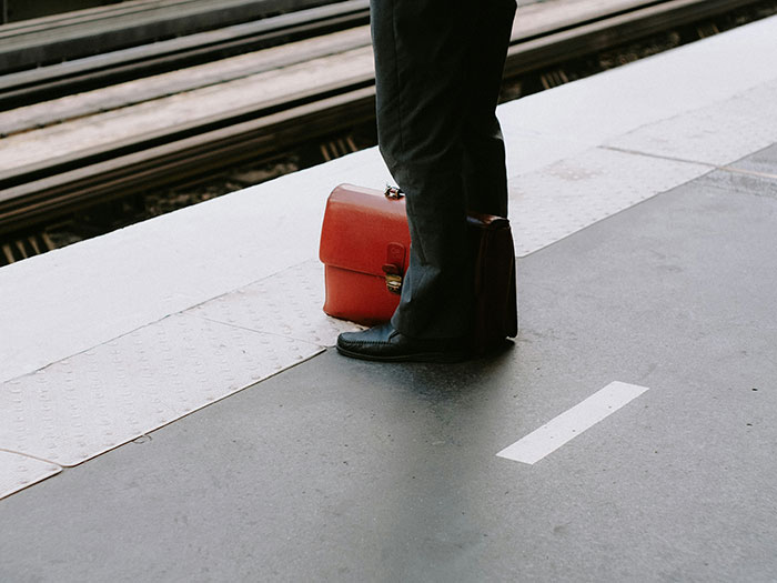 Man standing at train platform with briefcase, symbolizing man promises quiet life with two kids and stepdaughter conflict. Man standing at train platform with briefcase, symbolizing man promises quiet life with two kids and stepdaughter conflict.