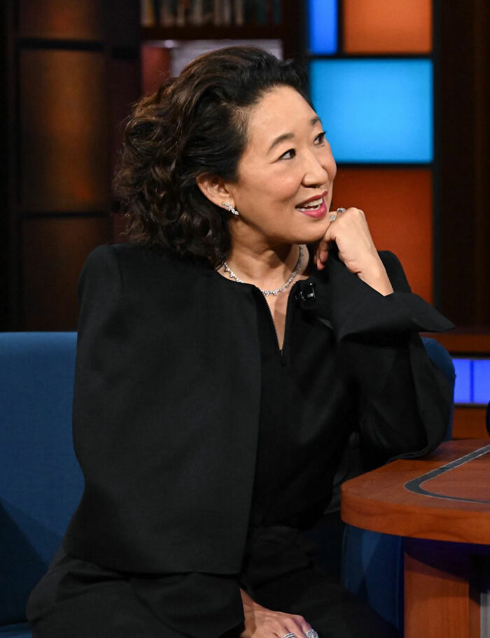 Woman in a black outfit smiling during a TV interview, related to Maxim faces backlash most unattractive women list. Woman in a black outfit smiling during a TV interview, related to Maxim faces backlash most unattractive women list.