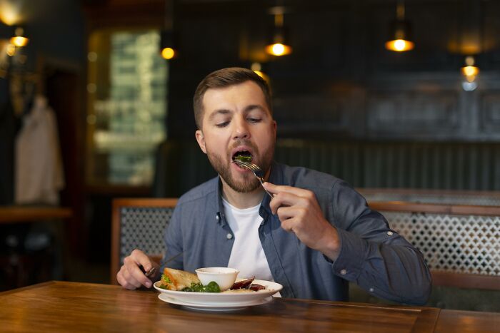 Man eating food at a restaurant, illustrating unique words that don’t exist in English but are used in other languages.