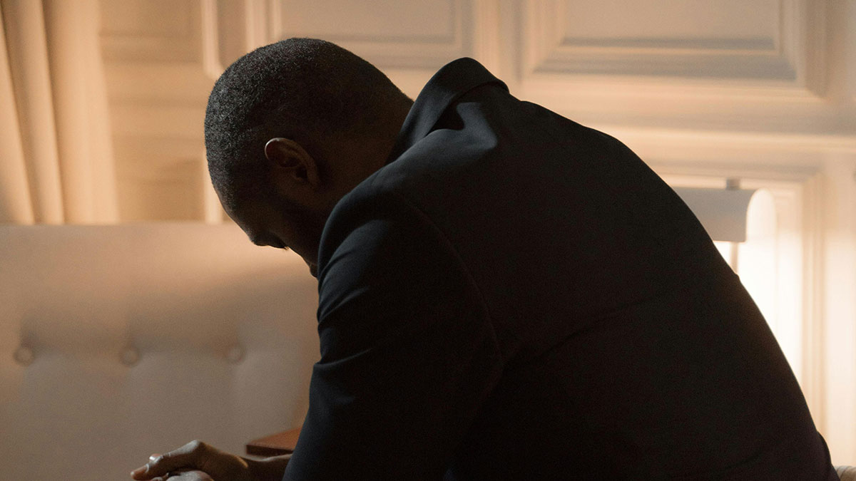 Young millionaire sitting alone, deep in thought, reflecting on life without friends in a quiet room.