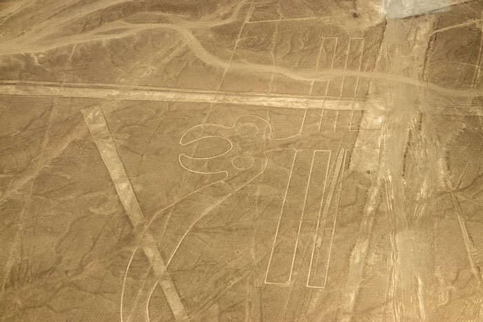 Aerial view of ancient geoglyphs etched in desert terrain, highlighting AI discovery of 303 significant geoglyphs. Aerial view of ancient geoglyphs etched in desert terrain, highlighting AI discovery of 303 significant geoglyphs.