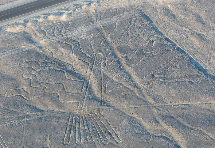 Aerial view of ancient geoglyphs etched in the desert, showcasing mysterious large-scale earth drawings discovered by AI. Aerial view of ancient geoglyphs etched in the desert, showcasing mysterious large-scale earth drawings discovered by AI.