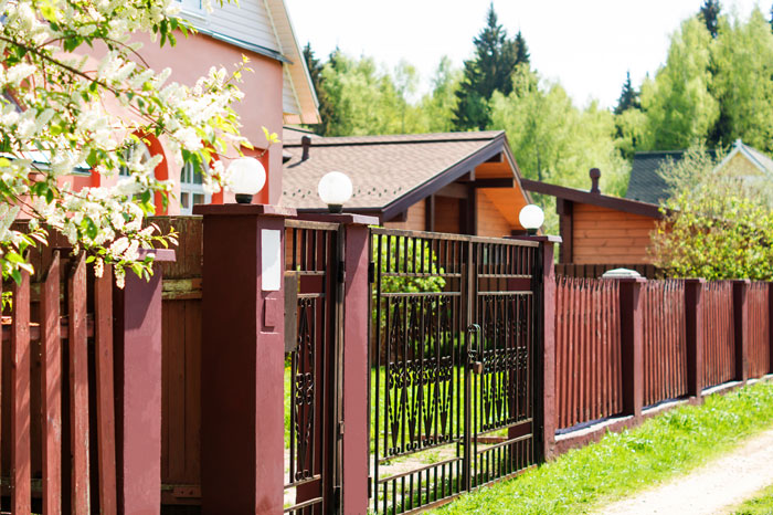 Wooden fence and gate in suburban yard, illustrating homeowner laughs in entitled neighbor’s face over fence dispute.