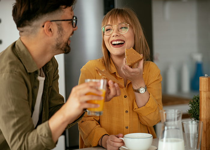 Couple enjoying breakfast together indoors, representing a neighbor refusing tourists patio use and Airbnb host dispute concept. Couple enjoying breakfast together indoors, representing a neighbor refusing tourists patio use and Airbnb host dispute concept.