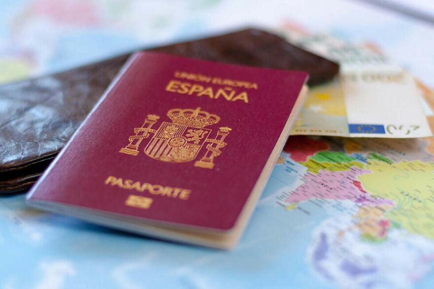 Spanish passport on a travel map with money and wallet, illustrating expired passport and home alone vibes incident. Spanish passport on a travel map with money and wallet, illustrating expired passport and home alone vibes incident.