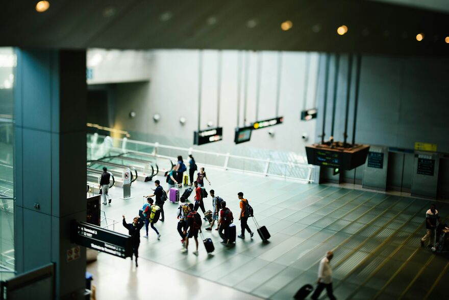 Group of travelers with luggage walking inside a modern airport terminal capturing home alone vibes and passport expired issue. Group of travelers with luggage walking inside a modern airport terminal capturing home alone vibes and passport expired issue.