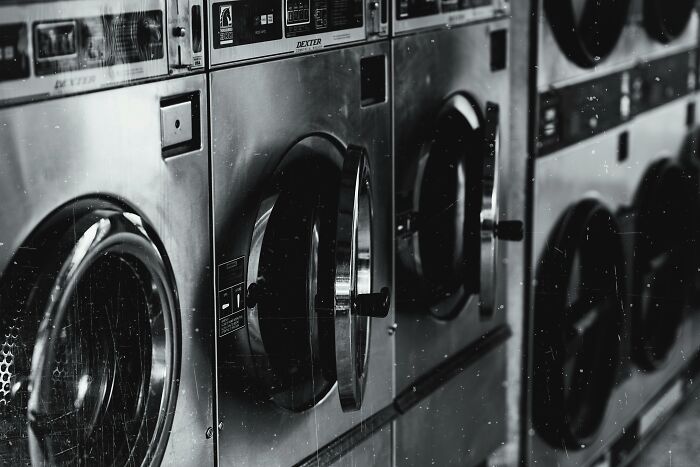 Row of industrial washing machines in a laundromat, depicting moments people decided to leave in frustration.