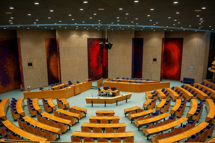 Empty legislative chamber with curved seating arrangement, representing concepts of USA direct democracy and governance. Empty legislative chamber with curved seating arrangement, representing concepts of USA direct democracy and governance.