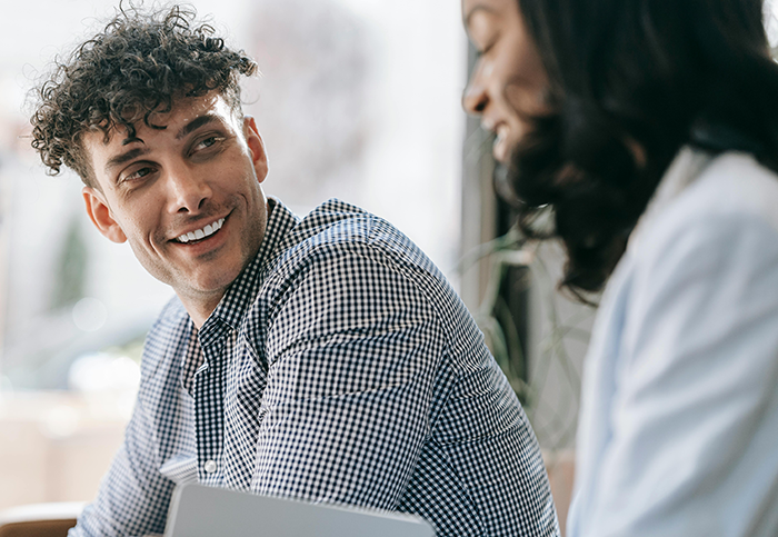 Worker and woman in office setting during a lunchtime conversation, highlighting a bizarre ritual and workplace confrontation.