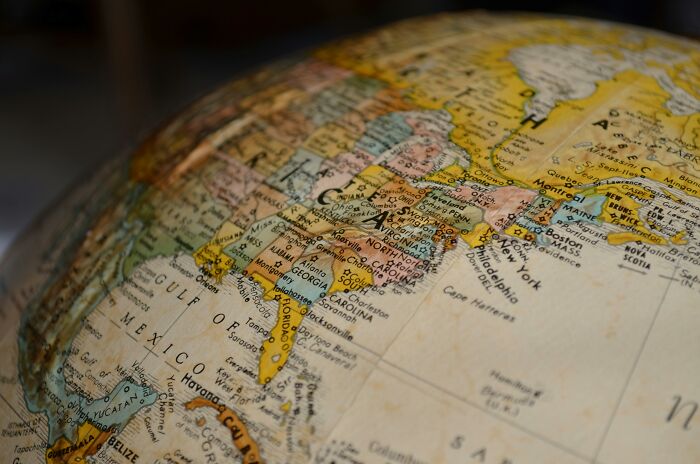 Close-up of a globe showing countries and cities with names in different languages for geography and language learning. Close-up of a globe showing countries and cities with names in different languages for geography and language learning.