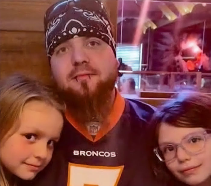 Man posing with his two daughters, captured in a heartfelt moment before the tragic explosion incident. Man posing with his two daughters, captured in a heartfelt moment before the tragic explosion incident.