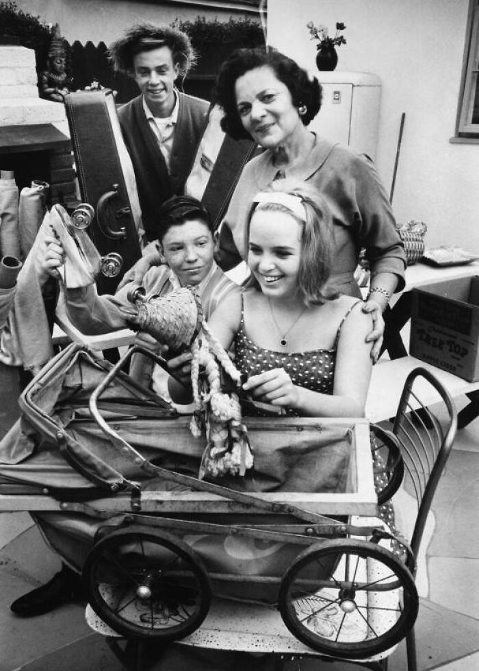 LA women in 1962 enjoying family time with children and vintage stroller in a warm, joyful moment.