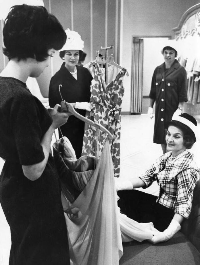 LA women shopping and trying on elegant dresses in a boutique, living their best lives in 1962.