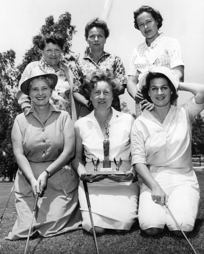 Group of LA women golfers posing with trophy outdoors, showcasing women living their best lives in 1962.