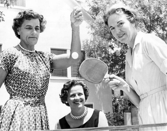 Three LA women living their best lives in 1962 playing outdoor ping pong on a sunny day.