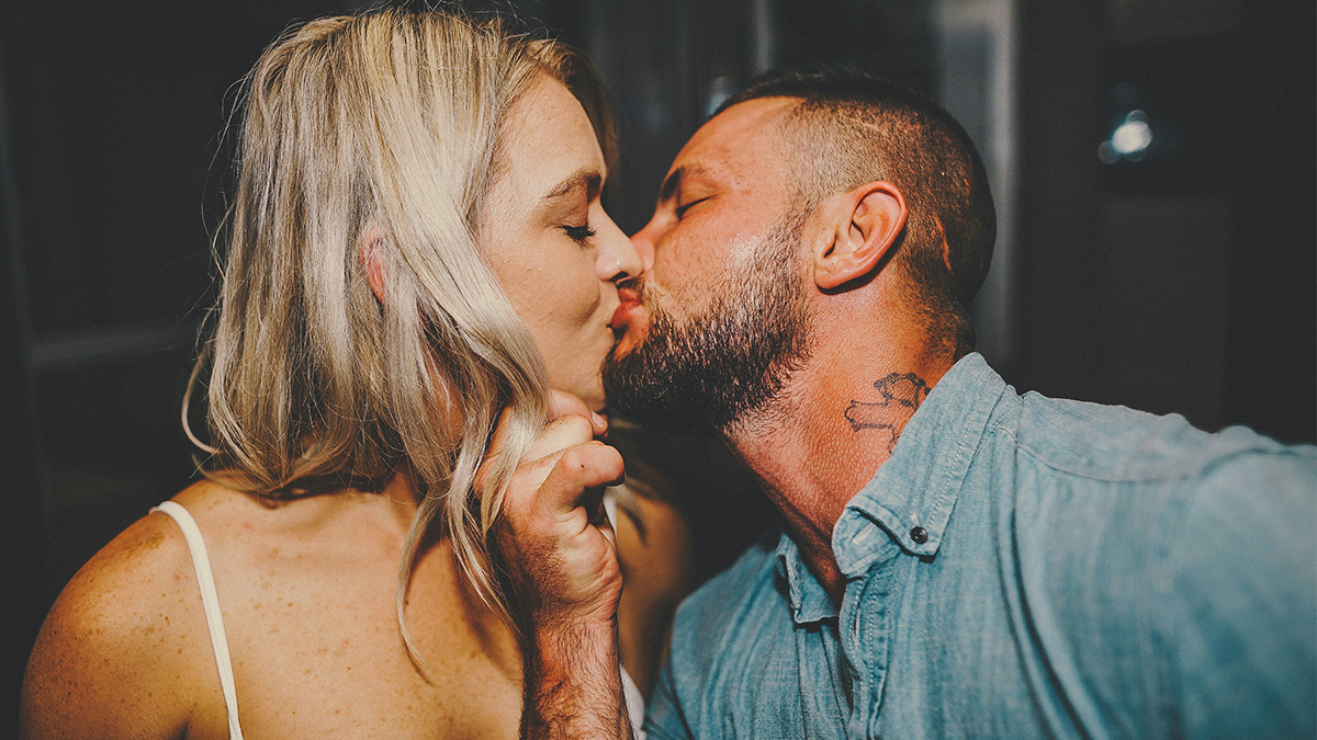 Poor woman and rich guy sharing a close kiss, showing how dating changed her life and brought new experiences.