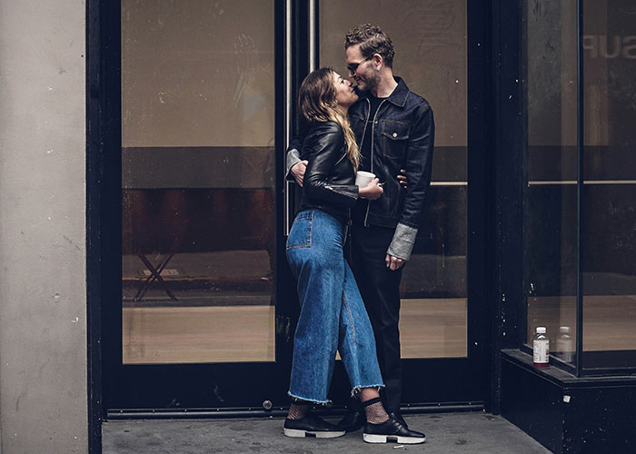 A couple embracing outside a storefront, showing a moment of connection and quick reactions preventing tragedy.