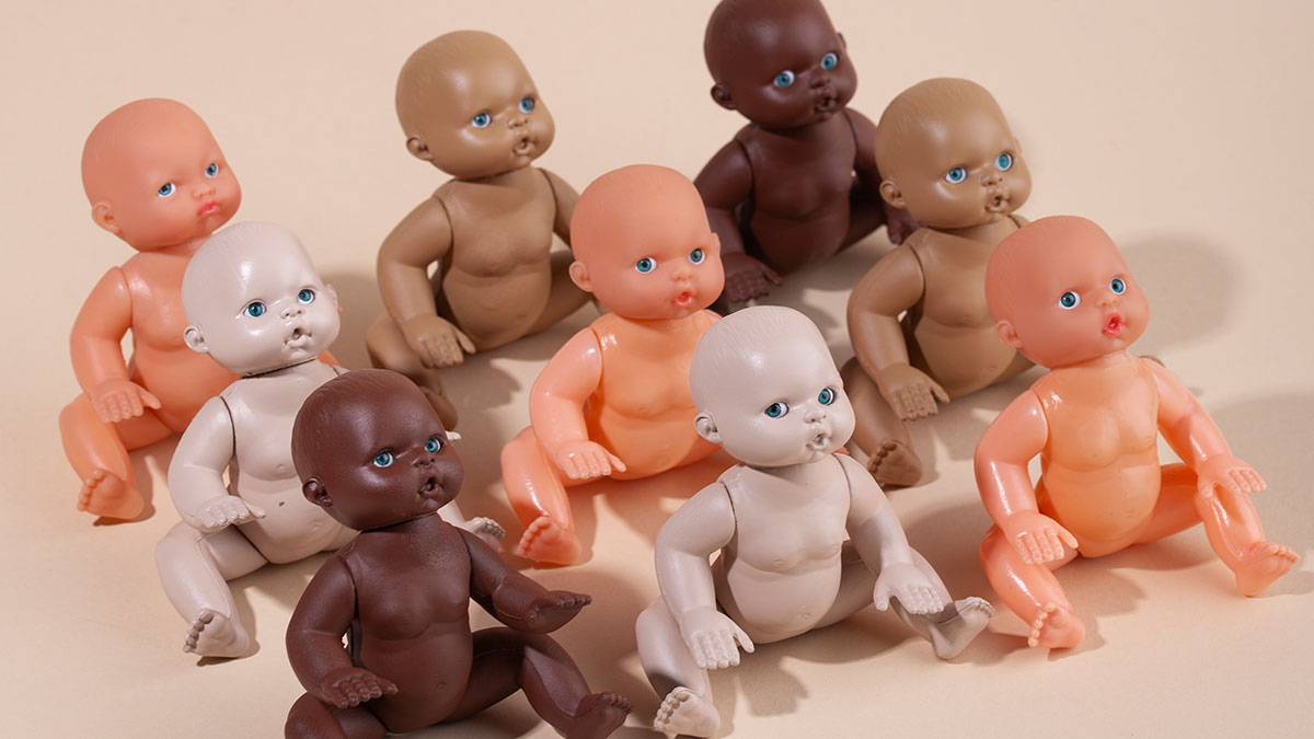 Nine diverse plastic dolls sitting on a beige surface, representing rage room customers who need therapy.