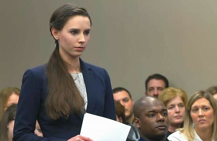 Young woman in a courtroom setting holding papers, one of 42 videos that don’t seem special until you know more context.