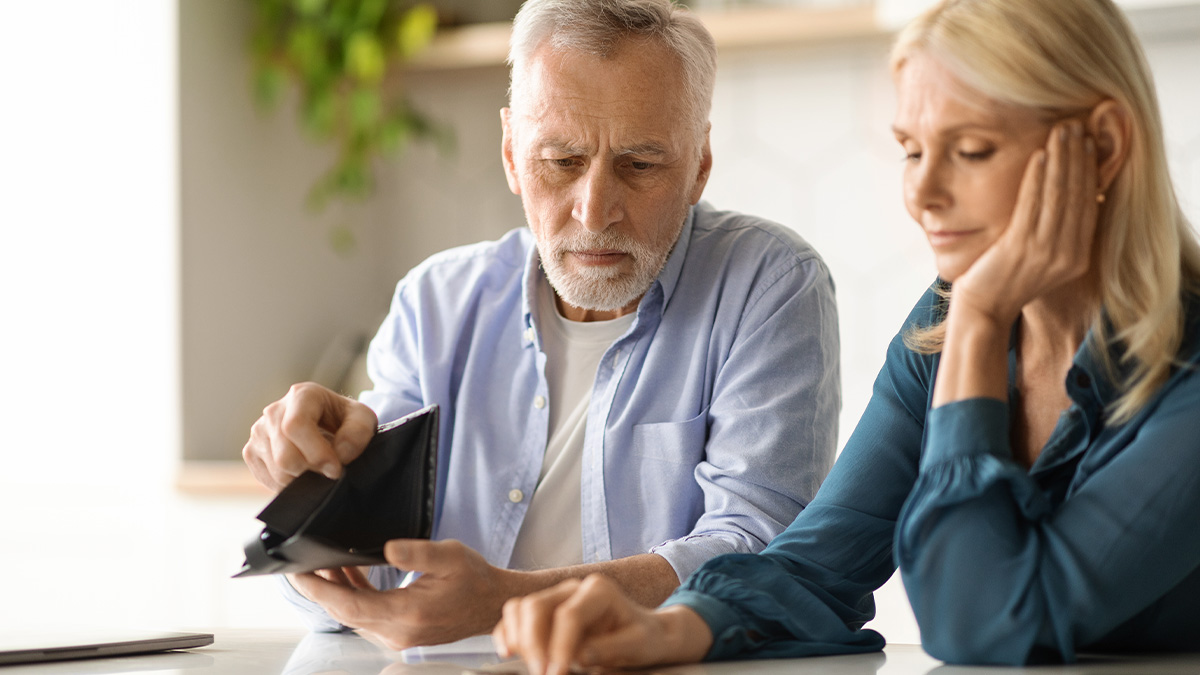 Elderly parents looking worried as they show an empty wallet, expecting daughter to support after losing savings.