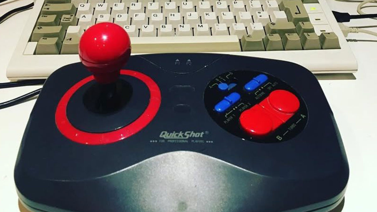 Retro gaming joystick and vintage computer keyboard setup evoking strong nostalgia from the 80s, 90s, and 00s era.