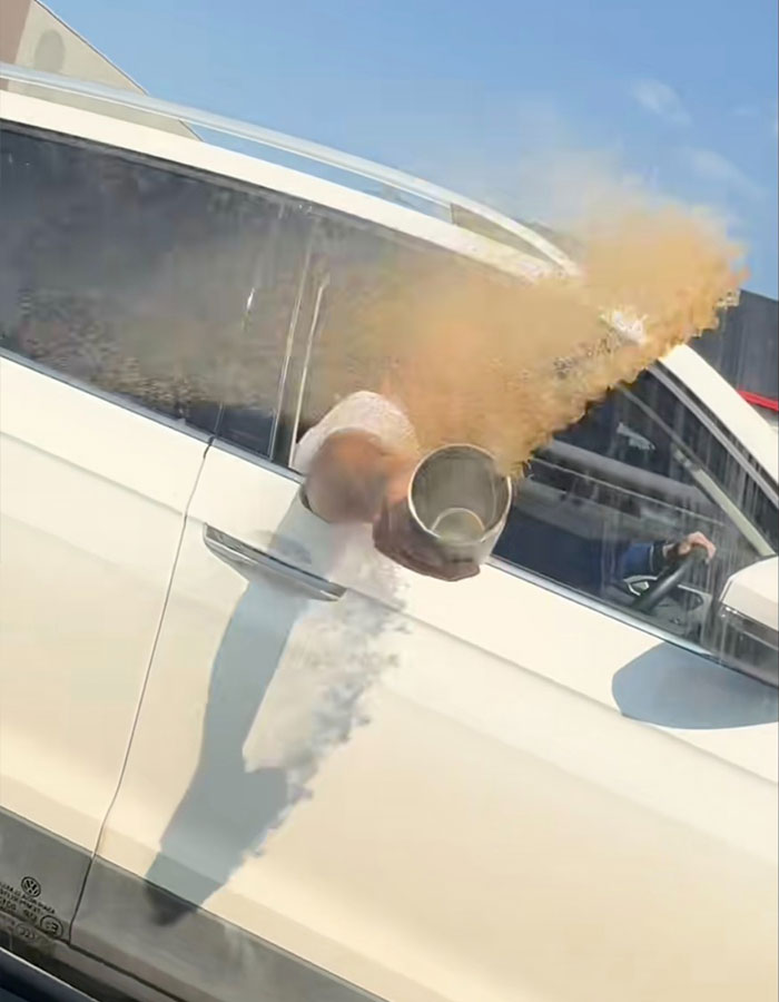 Passenger in white car tossing coffee outside window during road rage incident in viral instant karma video. Passenger in white car tossing coffee outside window during road rage incident in viral instant karma video.