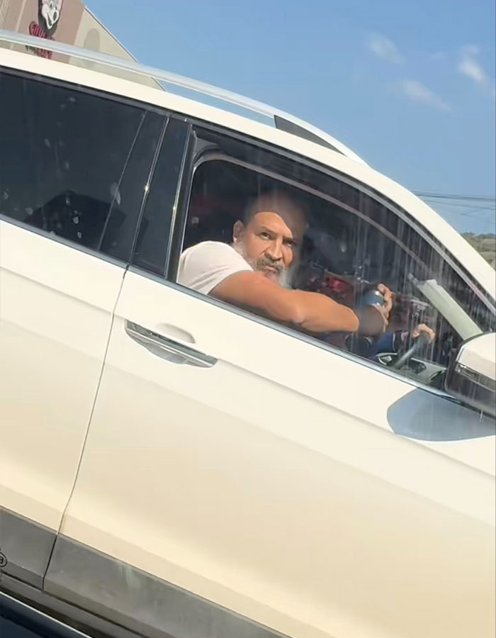 Man in white car showing road rage during coffee toss incident captured in viral instant karma video. Man in white car showing road rage during coffee toss incident captured in viral instant karma video.