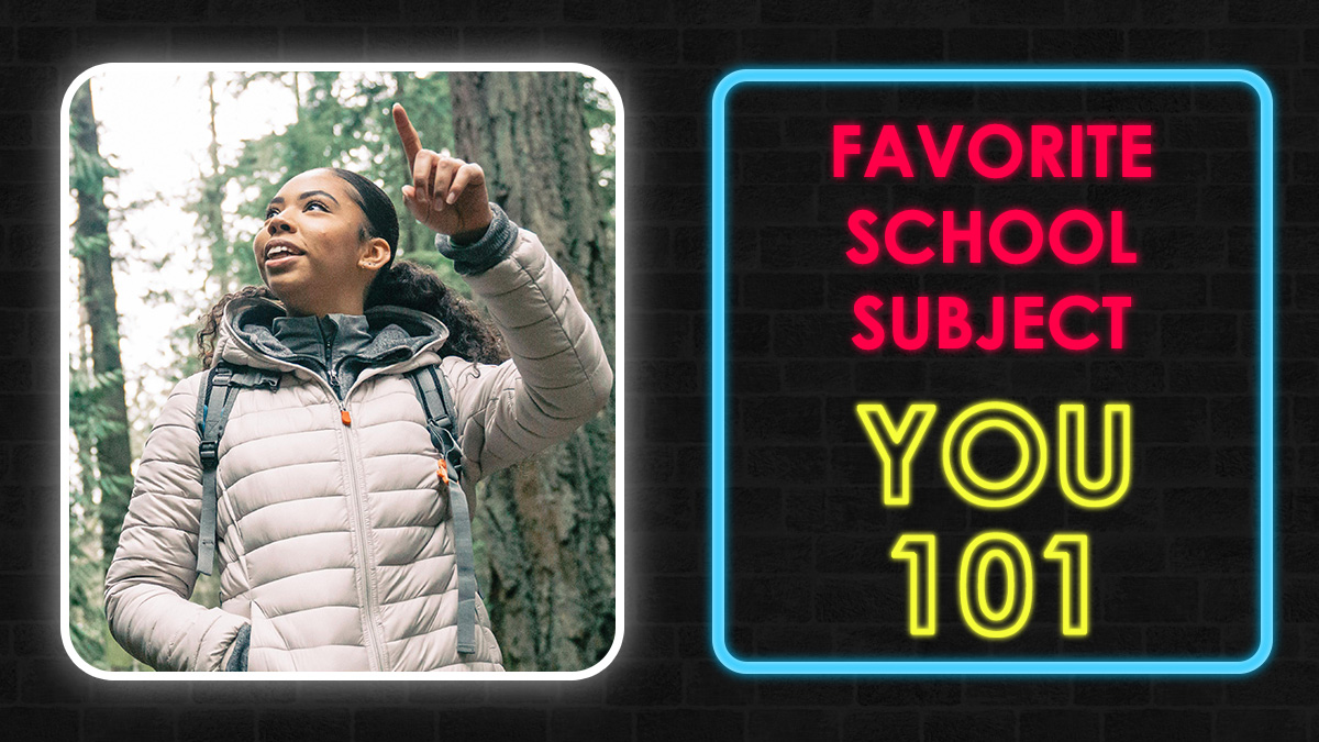 Young woman in jacket pointing while outdoors next to neon sign reading favorite school subject you 101 quiz