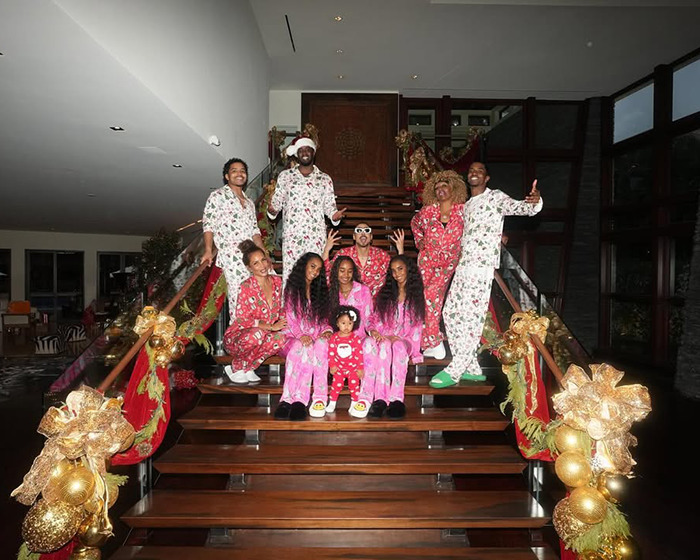 Sean Diddy's twin daughters wearing matching pajamas, sitting on holiday-decorated stairs after rollercoaster incident for rude behavior. Sean Diddy's twin daughters wearing matching pajamas, sitting on holiday-decorated stairs after rollercoaster incident for rude behavior.