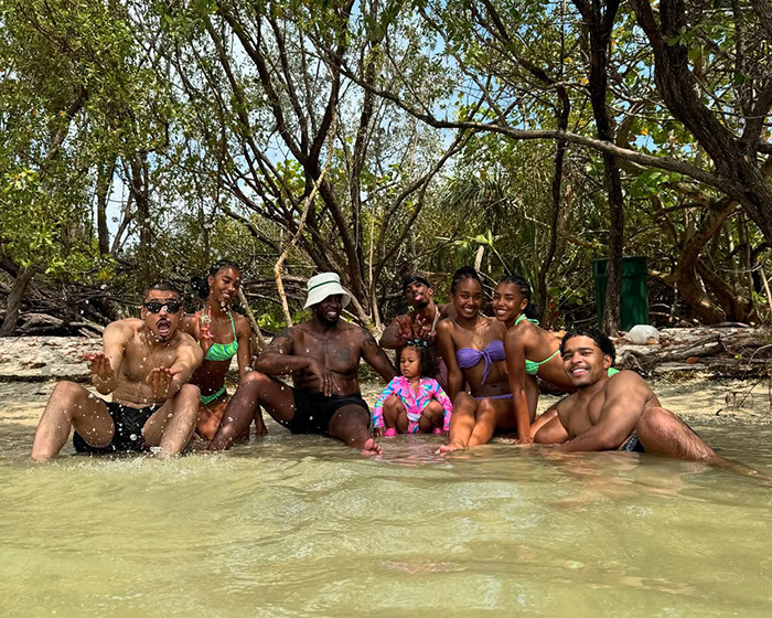 Sean Diddy Combs and family relaxing in the water at a tropical location surrounded by trees and greenery. Sean Diddy Combs and family relaxing in the water at a tropical location surrounded by trees and greenery.