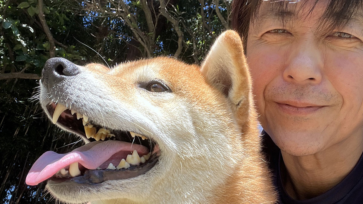 Man with his dog outdoors, highlighting the bond that helped him start a pet shelter after business collapse.